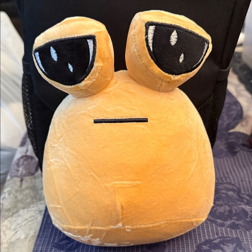 Alien Pou plush toy.